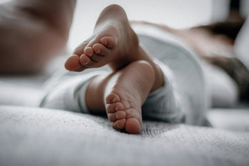 Parents helping child with sore legs — understanding growing pains in kids